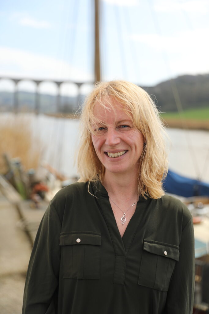 Olivia Dunn standing in front of Calstock Viaduct and the river Tamar